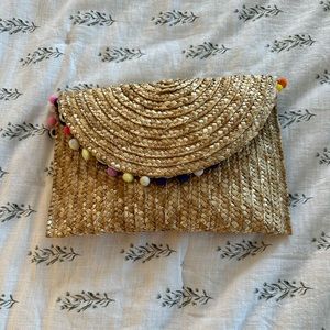 Tuckernuck straw clutch with colorful Poms.